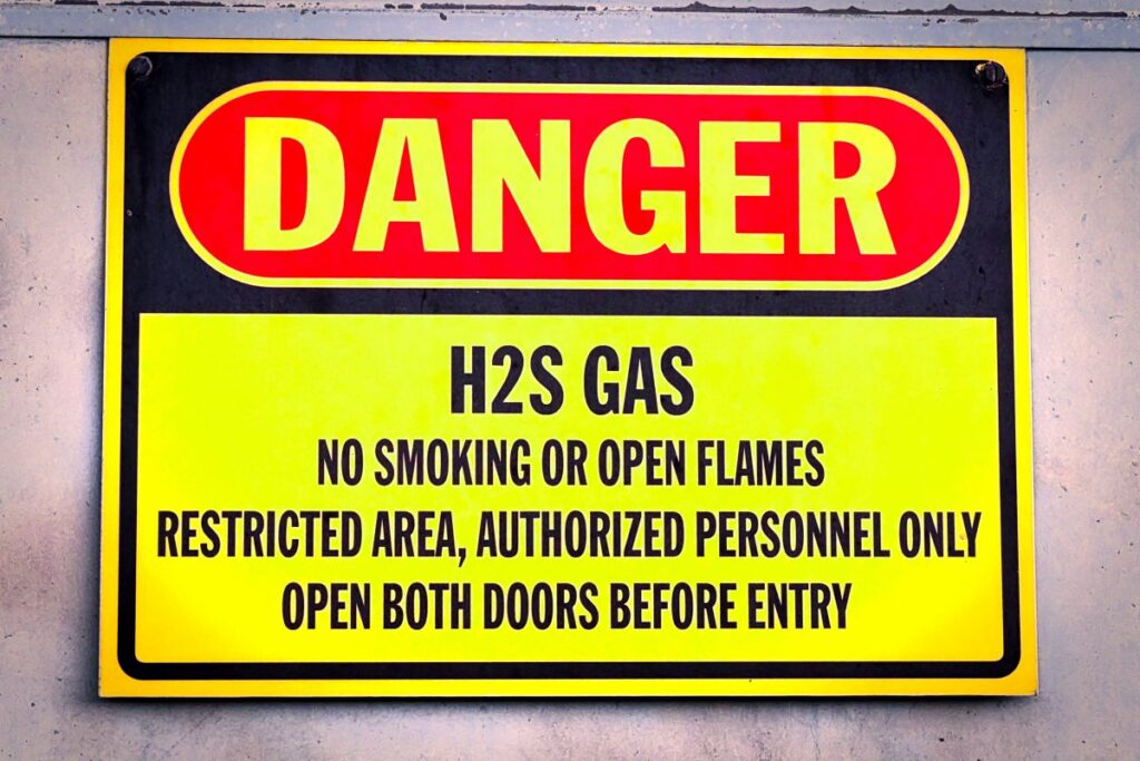 Closeup of a yellow Danger H2S Gas sign in Minnesota