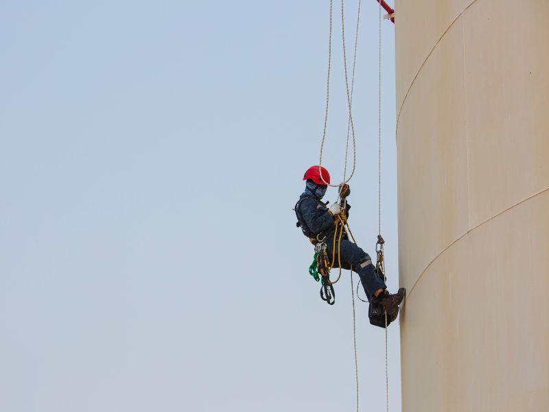 Man on side of building for OSHA fall protection training in North Dakota