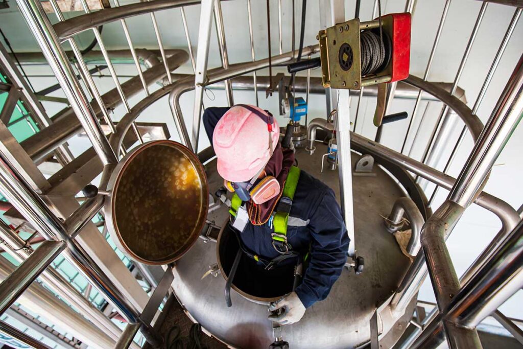 Man in small space for OSHA confined space training in Colorado
